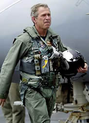  Bush walks the deck of the aircraft carrier USS Abraham Lincoln after landing there aboard an S-3B Viking, as the carrier steamed toward San Diego, California on May 1, 2003