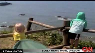 Ecola State Park, Oregon. Alaina Pitton falls over a low fence rail in this still from home video. Right behind her is a 150-foot cliff.