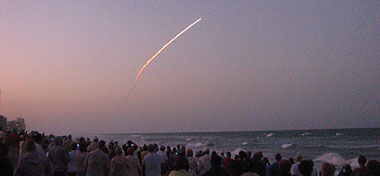 Onlookers watch the Space Shuttle Discovery as seen from Jensen Beach Florida